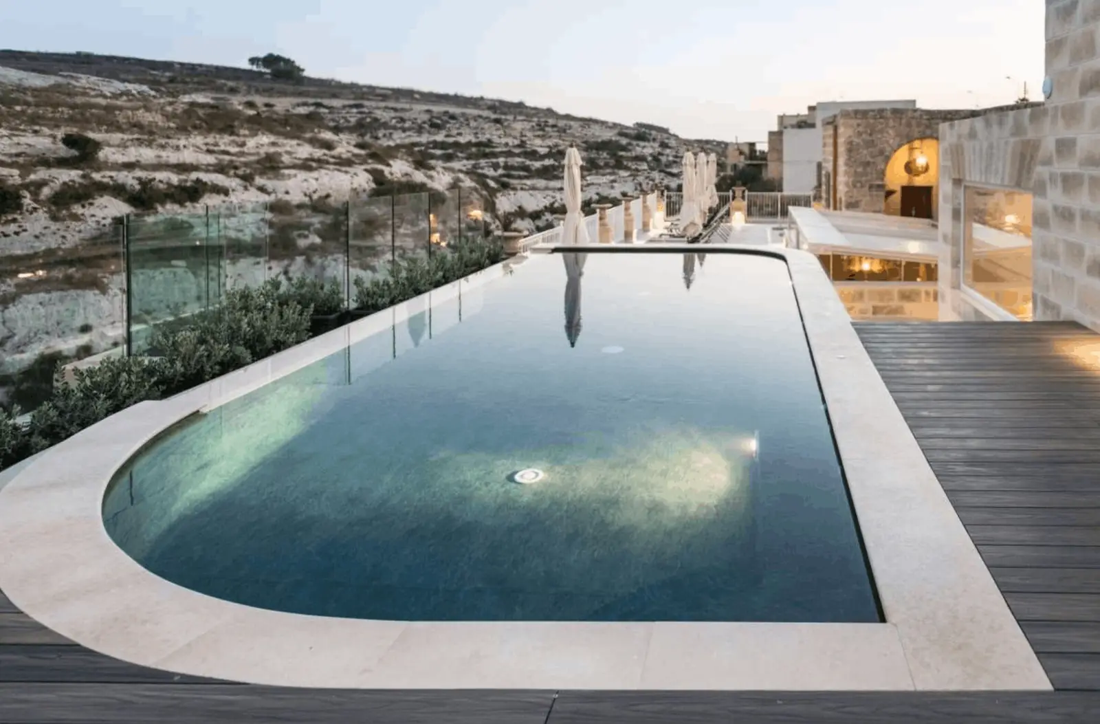 The infinity pool and deck overlooking Xlendi Valley at Cesca Boutique Hotel on Gozo, Malta