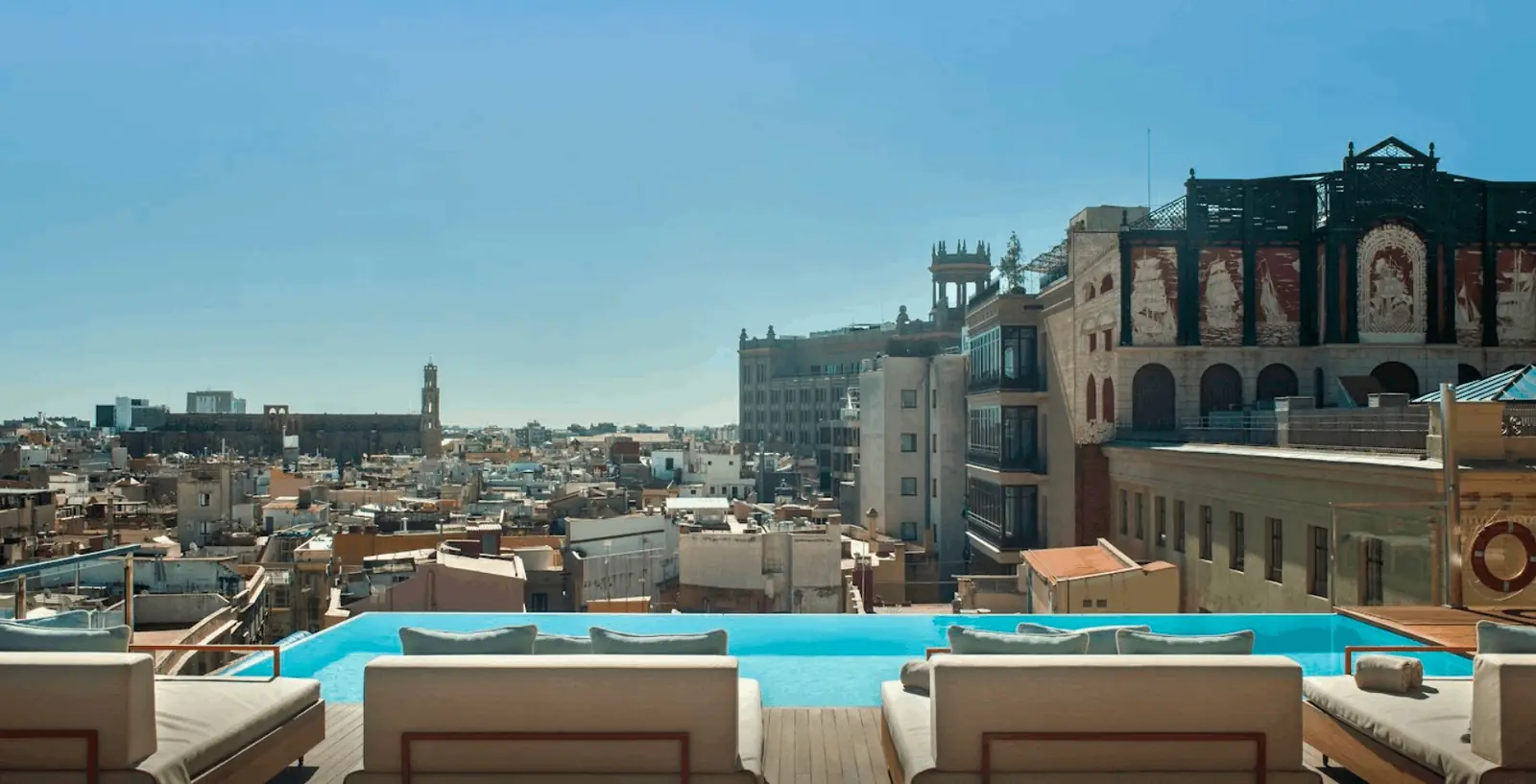 The rooftop infinity pool at Grand Hotel Central overlooking Barcelona's old town, Spain