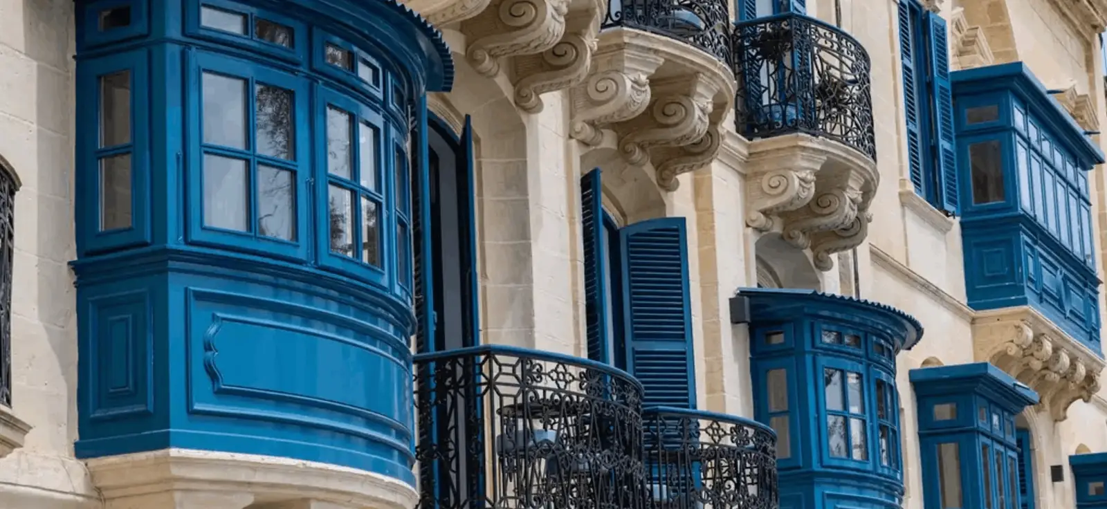 The restored palazzo facade and traditional blue Maltese balconies at Iniala Harbour House, Valletta