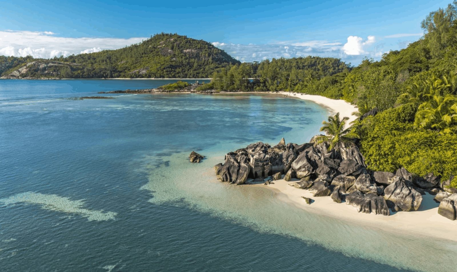 A granite-boulder beach and turquoise water on Mahé in the Seychelles