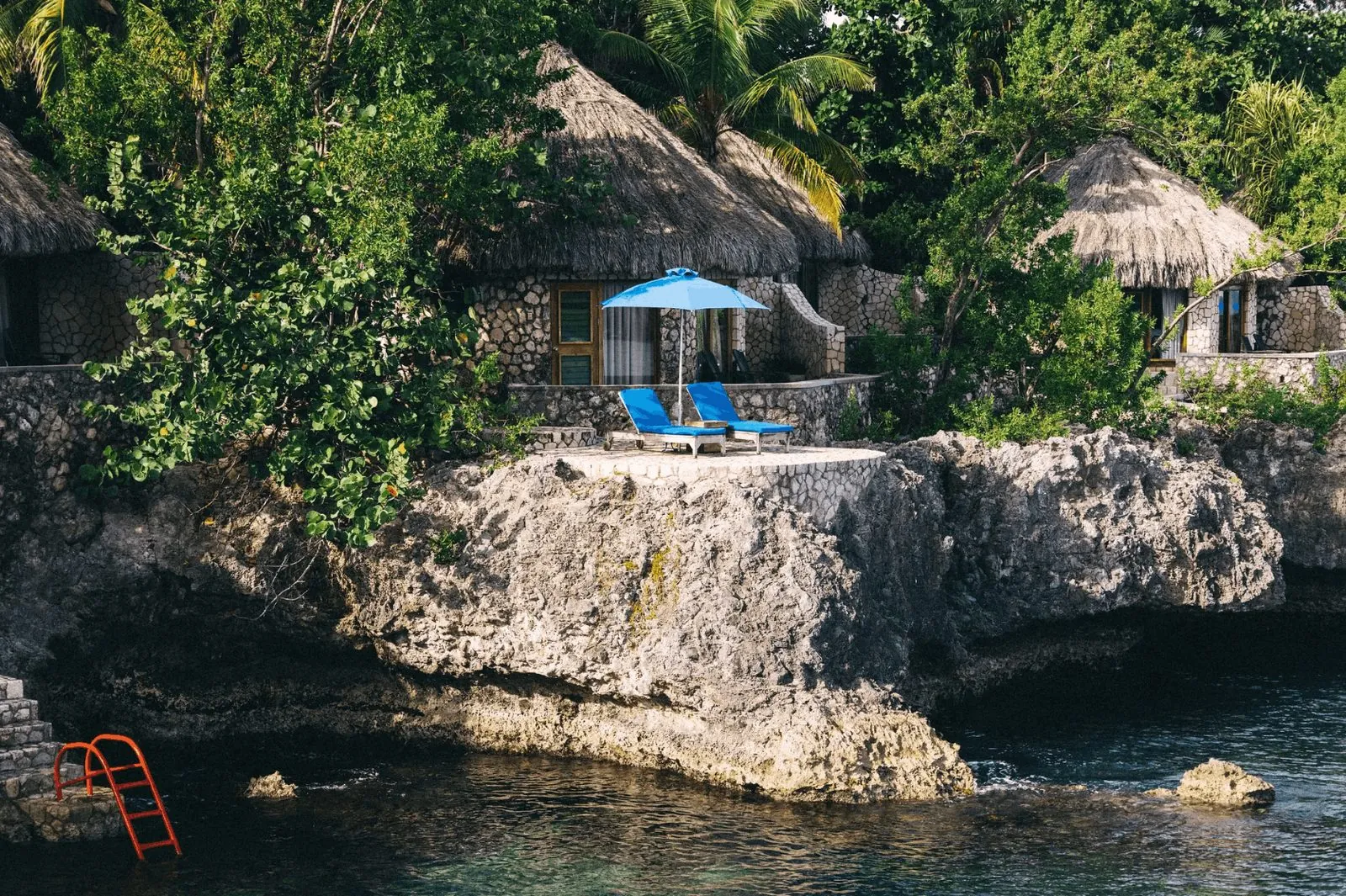 Thatched villas overlooking the Caribbean Sea at Rockhouse Hotel in Negril, Jamaica