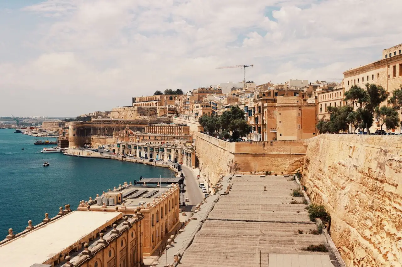 Valletta's honey-stone fortifications and buildings lining the Grand Harbour in Malta