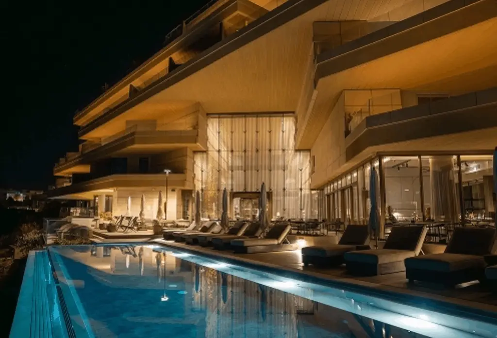 The illuminated outdoor pool and loungers at Verdala Wellness Hotel near Rabat, Malta at dusk