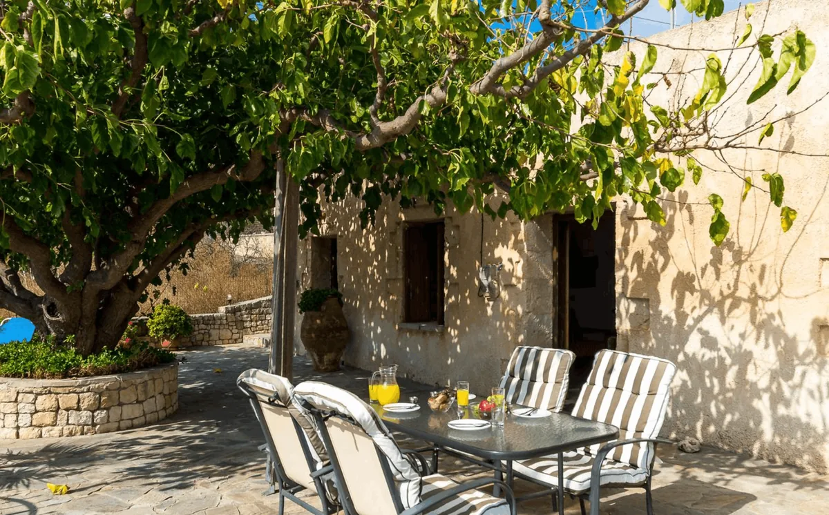 Artemis villa above Aptera in northwest Crete, a small stone house with a veranda shaded by a mulberry tree.
