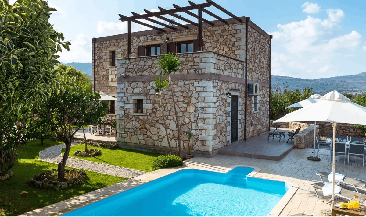 Villa Chryssa near Chania, a stone house with a private pool and olive groves below the White Mountains in Crete.