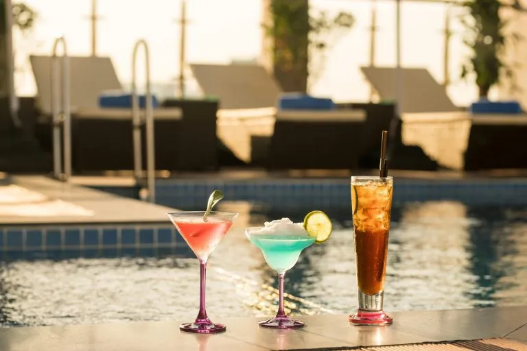 Colorful cocktails by a poolside under the afternoon sun in Phnom Penh.