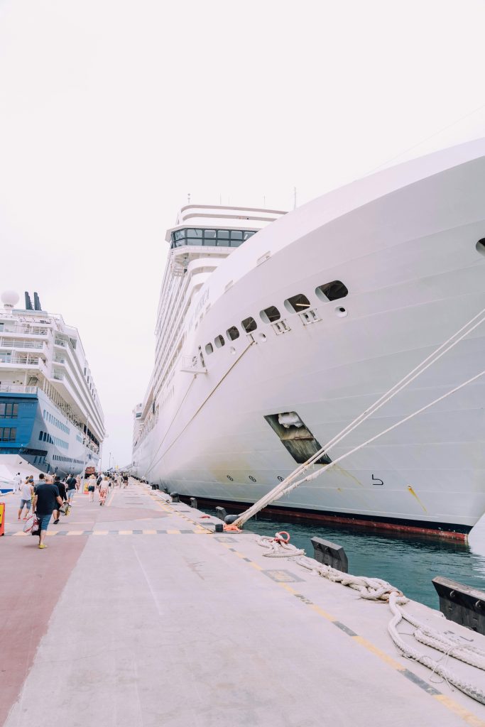 A pair of luxury cruise ships docked at a harbor, ready for leisure travelers.