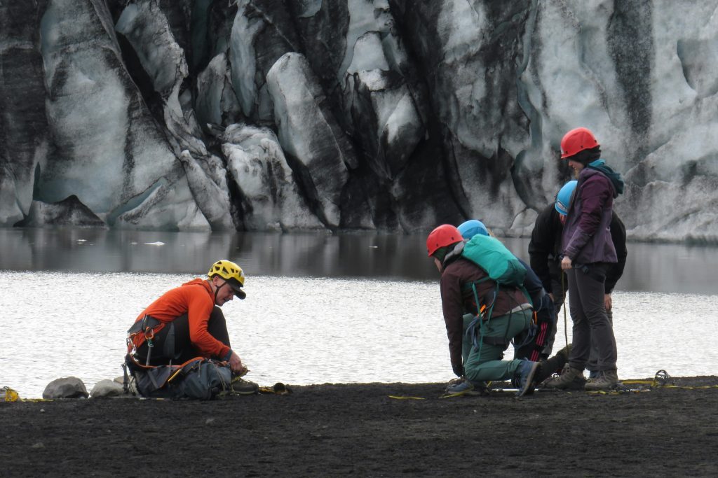 Group of climbers preparing for glacier hike at Vík í Mýrdal, Iceland.